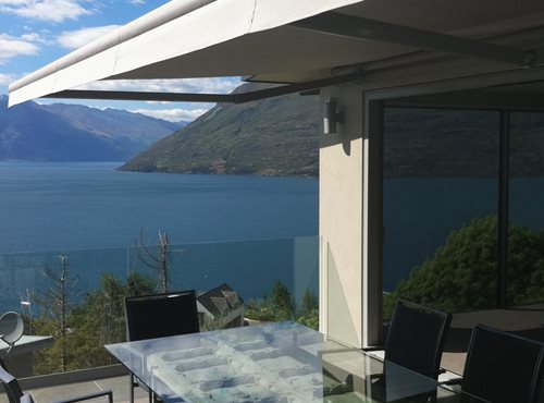 Euro awning open over balcony dining area overlooking Queenstown