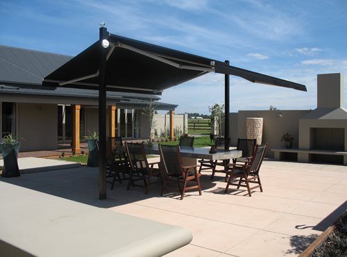 Outdoor canopy open over outdoor dining table