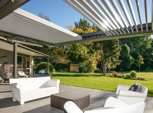 Outdoor heaters hanging on louver structure over sitting area
